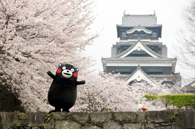 Kumamon posing in front of Kumamoto Castle